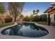 Stunning backyard pool surrounded by lush landscaping, and mature palm trees at dusk at 24121 N 24Th Pl, Phoenix, AZ 85024