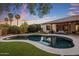 Inviting backyard pool with lush landscaping, perfect for relaxing and entertaining at twilight at 24121 N 24Th Pl, Phoenix, AZ 85024