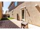 Back patio area with pavers, artificial turf, and a side entrance into the home at 2543 N 73Rd Dr, Phoenix, AZ 85035