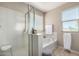 Bathroom with shower, soaking tub, and natural light from a window with blinds at 2543 N 73Rd Dr, Phoenix, AZ 85035