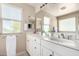 Bathroom featuring a double vanity with white cabinets and bright, natural light at 2543 N 73Rd Dr, Phoenix, AZ 85035