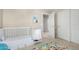 Cozy Bedroom with white furniture, including crib and changing table, and playful alphabet rug at 2543 N 73Rd Dr, Phoenix, AZ 85035