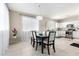 Bright dining room with modern chandelier, seating for six, and seamless flow to the kitchen at 2543 N 73Rd Dr, Phoenix, AZ 85035