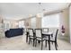 Bright dining room with modern chandelier, seating for six, and seamless flow to the living area at 2543 N 73Rd Dr, Phoenix, AZ 85035