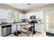 Modern kitchen featuring white cabinets, stainless steel appliances, and a movable island at 2543 N 73Rd Dr, Phoenix, AZ 85035