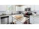 Modern kitchen featuring white cabinets, stainless steel appliances, and a movable island at 2543 N 73Rd Dr, Phoenix, AZ 85035
