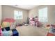 Fun playroom with toys, play kitchen, and natural light from two windows at 2543 N 73Rd Dr, Phoenix, AZ 85035