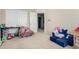 Spacious playroom featuring soft carpet, toys, and a cozy reading nook at 2543 N 73Rd Dr, Phoenix, AZ 85035