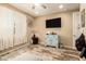 Neutral bedroom featuring hardwood floors, a ceiling fan, and a window with natural light at 25955 W Deer Valley Rd, Buckeye, AZ 85396