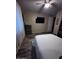 Relaxing bedroom featuring a comfortable bed, dark wood furniture, and an entertainment setup at 25955 W Deer Valley Rd, Buckeye, AZ 85396