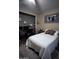 Inviting bedroom featuring a comfortable bed, modern decor, and a glimpse into a home office space at 25955 W Deer Valley Rd, Buckeye, AZ 85396