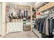 Walk-in closet with ample storage including hanging rods, shelving, a dresser, and drawer storage at 25955 W Deer Valley Rd, Buckeye, AZ 85396