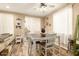Cozy dining area with wood-look tile, a dining table with seating for four, and sliding door access to patio at 25955 W Deer Valley Rd, Buckeye, AZ 85396