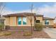 Inviting single-story home with a neutral stucco exterior, tile roof, and low-maintenance landscaping at 25955 W Deer Valley Rd, Buckeye, AZ 85396