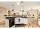 Open concept kitchen with white cabinetry, a black dishwasher, sink, and access to the breakfast nook at 25955 W Deer Valley Rd, Buckeye, AZ 85396