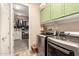 A modern laundry room with stainless steel washer and dryer plus walk-in closet at 25955 W Deer Valley Rd, Buckeye, AZ 85396