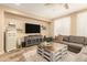 Cozy living room featuring hardwood floors, a ceiling fan, and comfortable seating area at 25955 W Deer Valley Rd, Buckeye, AZ 85396