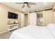 Serene main bedroom with a ceiling fan, a barn door, and a neutral color palette, with a view to the ensuite at 25955 W Deer Valley Rd, Buckeye, AZ 85396
