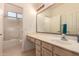 Bright bathroom with a sink and mirror as well as a shower in the background at 321 W Betsy Ln, Gilbert, AZ 85233