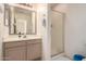Bathroom features single sink vanity, large mirror, and glass shower at 321 W Betsy Ln, Gilbert, AZ 85233
