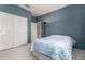 Comfortable bedroom featuring blue walls, soft carpet, closet space and a large window at 321 W Betsy Ln, Gilbert, AZ 85233