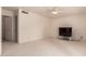 Minimalist bedroom with neutral carpet, ceiling fan, and ample natural light at 321 W Betsy Ln, Gilbert, AZ 85233