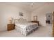 Cozy bedroom featuring floral comforter, ceiling fan, and bright natural light at 321 W Betsy Ln, Gilbert, AZ 85233