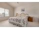 Bright bedroom with a floral comforter, ceiling fan, and large window at 321 W Betsy Ln, Gilbert, AZ 85233
