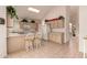 Eat-in kitchen featuring neutral cabinets, an island and tile flooring at 321 W Betsy Ln, Gilbert, AZ 85233