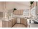 Bright kitchen with tile floor, island with seating, and ample counter space at 321 W Betsy Ln, Gilbert, AZ 85233