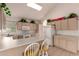 Spacious kitchen includes an island with seating, tiled floors, and white appliances at 321 W Betsy Ln, Gilbert, AZ 85233