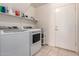 Laundry room featuring a modern washer and dryer, shelf space and an exterior door at 321 W Betsy Ln, Gilbert, AZ 85233
