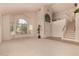 Spacious living room with arched windows and a view of the foyer at 321 W Betsy Ln, Gilbert, AZ 85233