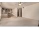 Bright living room featuring neutral carpet, ceiling fan and an open layout at 321 W Betsy Ln, Gilbert, AZ 85233