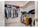 Spacious walk-in closet with built-in shelves and ample hanging space for organized storage at 321 W Betsy Ln, Gilbert, AZ 85233