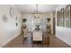 Well-lit dining room boasts rustic wood table, elegant chandelier, and charming wall decor at 3308 N 51St St, Phoenix, AZ 85018