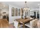 Elegant dining area with a wooden table, chandelier, and seamless flow into the kitchen at 3308 N 51St St, Phoenix, AZ 85018
