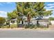 Charming single-story home with a well-manicured front yard, black fence and lush landscaping at 3308 N 51St St, Phoenix, AZ 85018
