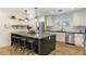 Modern kitchen featuring a large island with seating, stainless steel appliances, and white cabinetry at 3308 N 51St St, Phoenix, AZ 85018