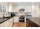 Well-lit kitchen showcasing sleek countertops, stainless steel appliances, and ample storage at 3308 N 51St St, Phoenix, AZ 85018
