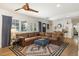 Inviting living room featuring a large sectional, stylish rug, and a modern ceiling fan at 3308 N 51St St, Phoenix, AZ 85018