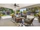 Inviting covered patio with stylish seating area, ceiling fan, and views of the pool and lush backyard at 3308 N 51St St, Phoenix, AZ 85018