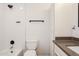This renovated bathroom has a step-in tub with shower, and modern grey countertops at 3337 W Yucca St, Phoenix, AZ 85029