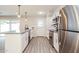 Updated kitchen with stainless steel appliances, white cabinetry, and modern fixtures at 3337 W Yucca St, Phoenix, AZ 85029
