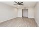 Spacious living room with contemporary floors, ceiling fan, and neutral walls at 3337 W Yucca St, Phoenix, AZ 85029
