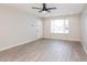 Bright living room featuring wood-look tile floors and a large front window at 3337 W Yucca St, Phoenix, AZ 85029