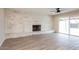 Spacious living room with a whitewashed fireplace, ceiling fan, and sliding glass door at 3337 W Yucca St, Phoenix, AZ 85029