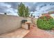 Backyard featuring a stone grill, gravel landscaping, and flowering bushes at 3631 E Long Lake Rd, Phoenix, AZ 85048
