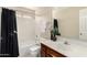 Well-lit bathroom featuring a tub, shower, and vanity with cherry-wood cabinets at 3631 E Long Lake Rd, Phoenix, AZ 85048