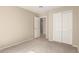 Neutral bedroom featuring carpet floors, closet with paneled doors, and an open doorway at 3631 E Long Lake Rd, Phoenix, AZ 85048